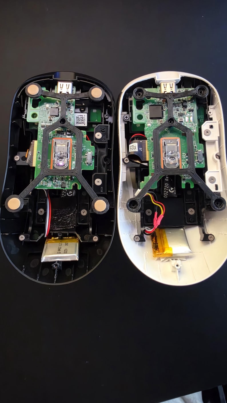 Two opened Logitech mouse builds showing the custom base parts and internal electronics